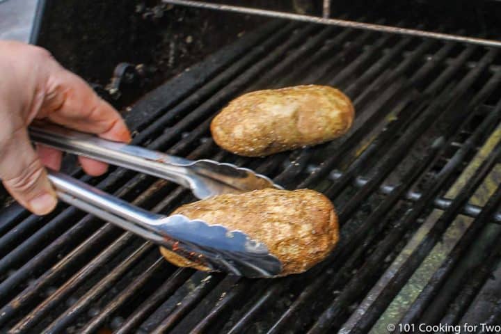 placing potatoes on the grill