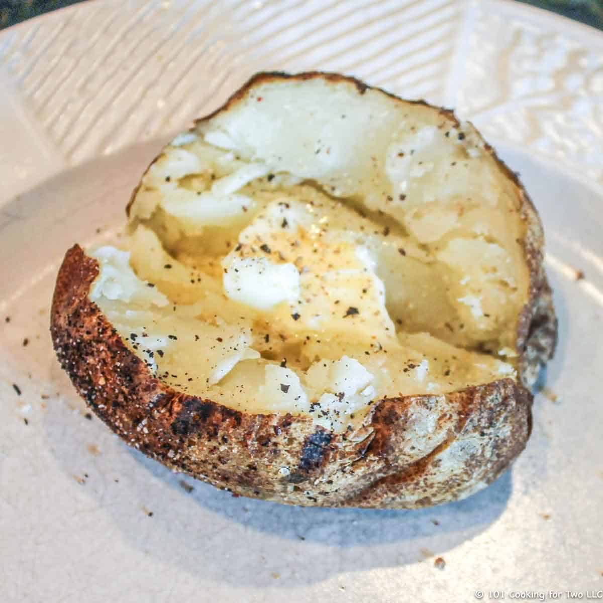 potato on plate seasoned with butter