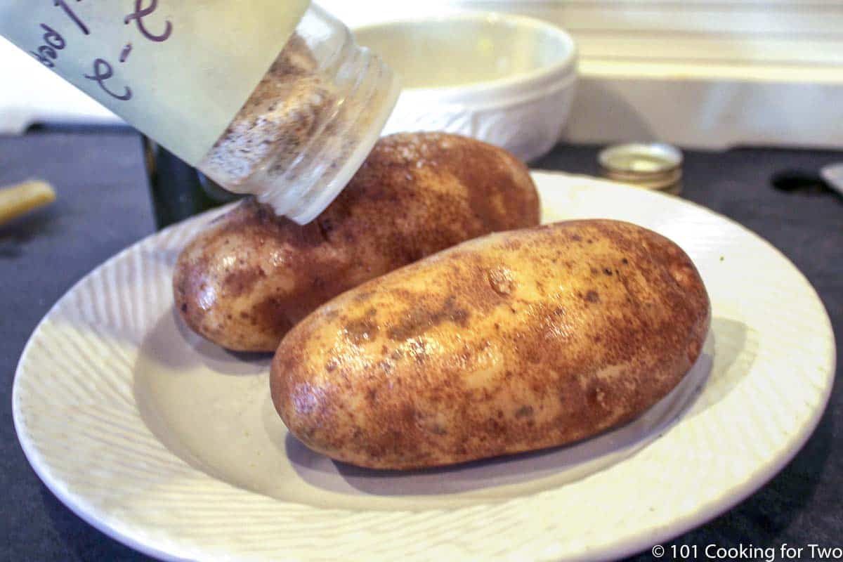 seasoning oiled potatoes.