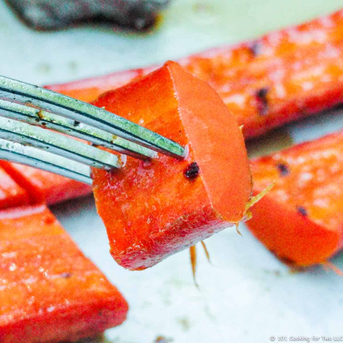 grilled carrot on fork.