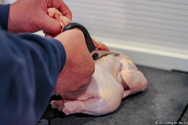 whole chicken with scissors being cut