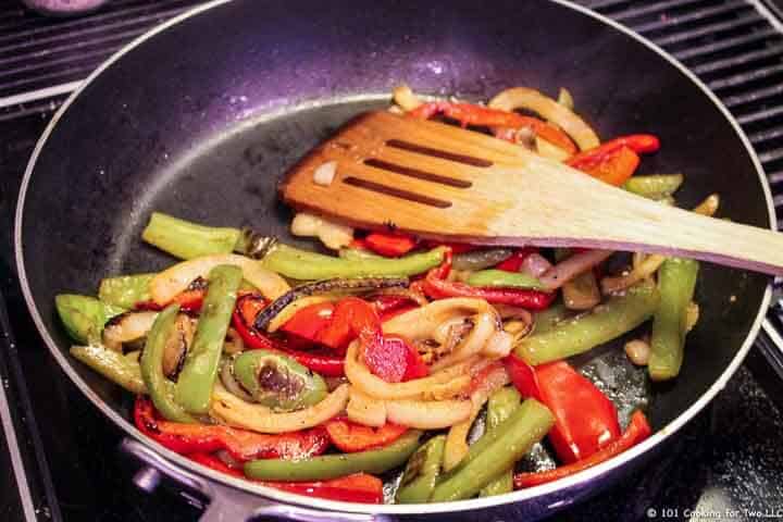 cook peppers and onion in fry pan