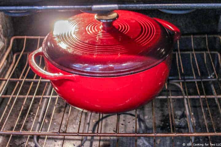 a red Dutch oven in the oven.