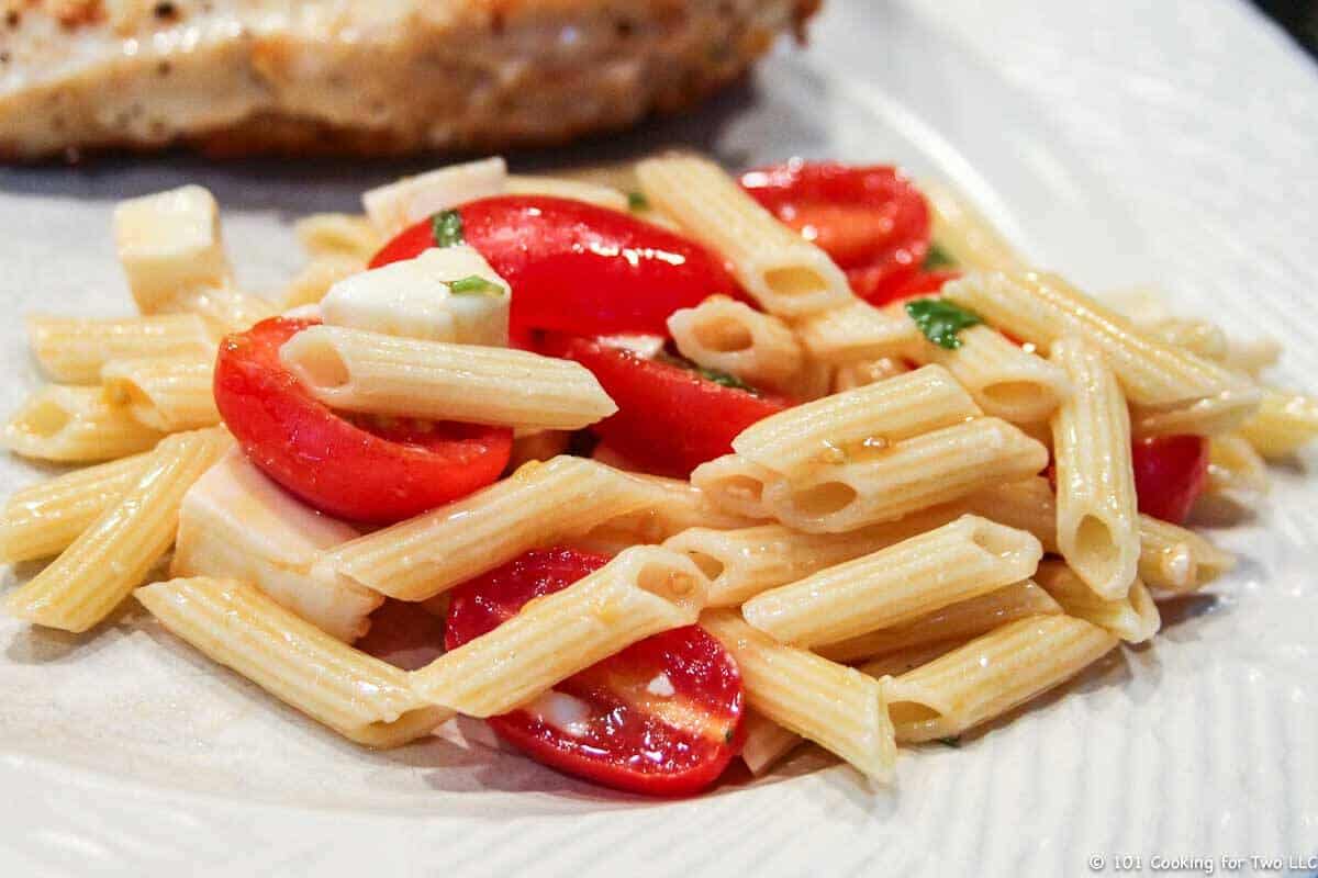 Caprese Pasta salad on a white plate