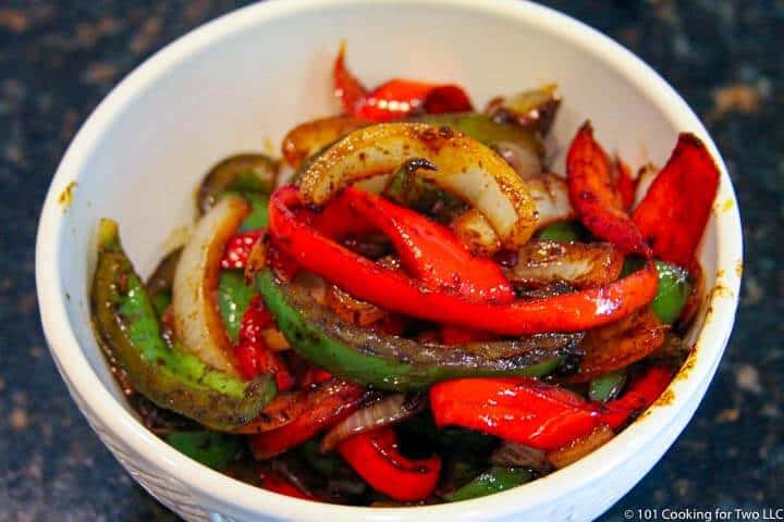 bowl full of cooked veggies.