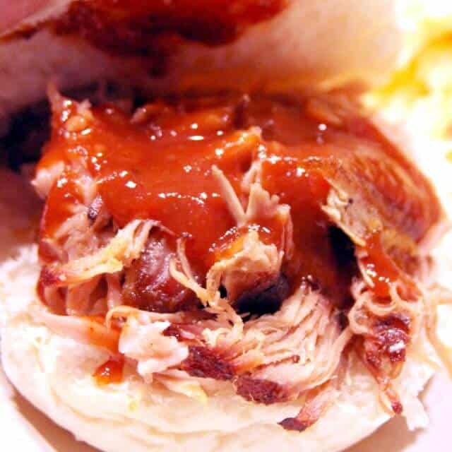 image of pulled pork in a bun with sauce