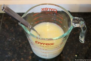 Mixing milk, oil and egg in cup