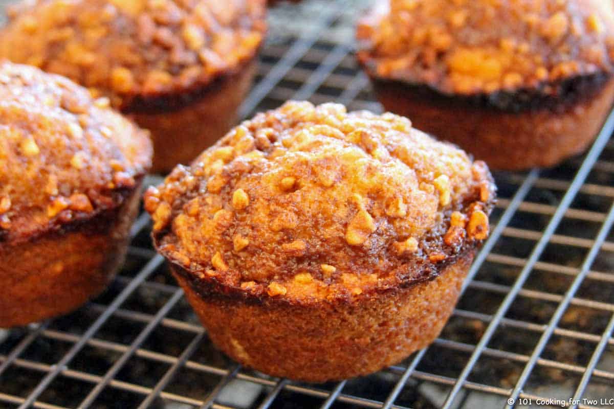 golden brown muffin on rack.