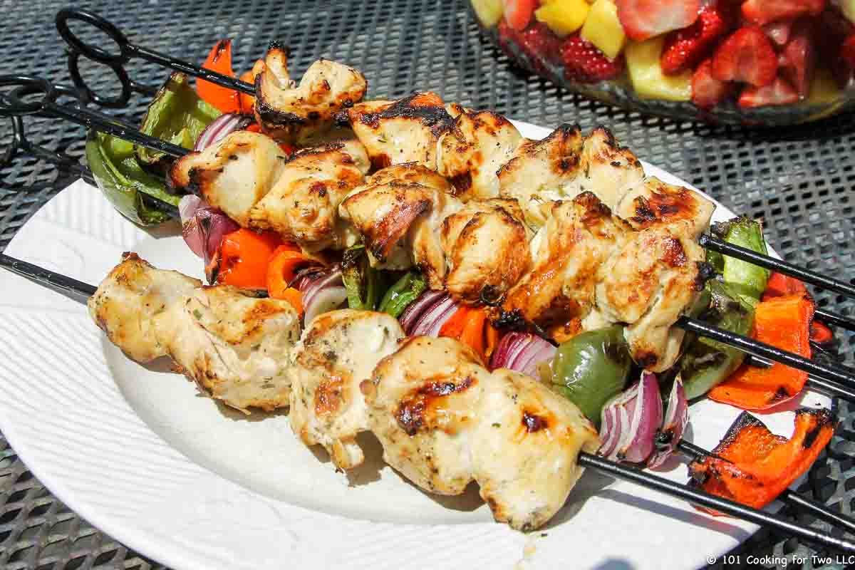 chicken kabobs cooked with some vegetables on plate.