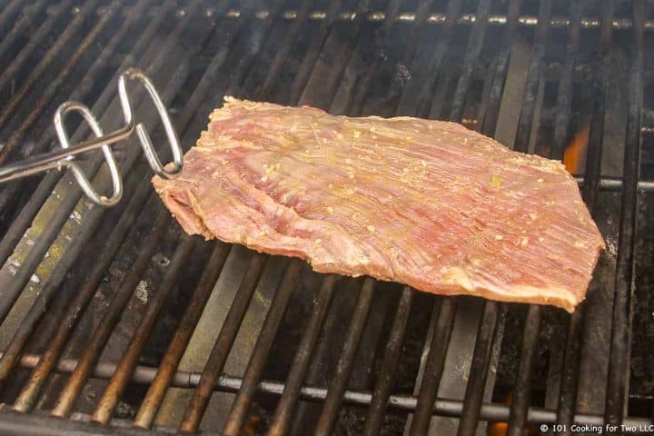flank steak going onto grill
