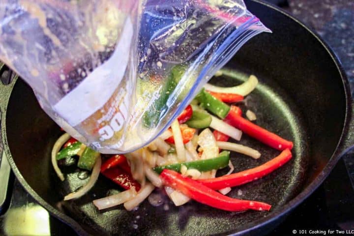 pouring vegetables into frying pan