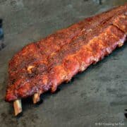 grilled Baby Back Ribs on black cutting board