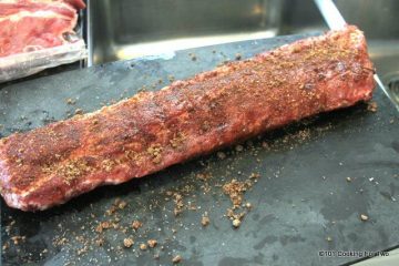 dry rubbed ribs on a black board