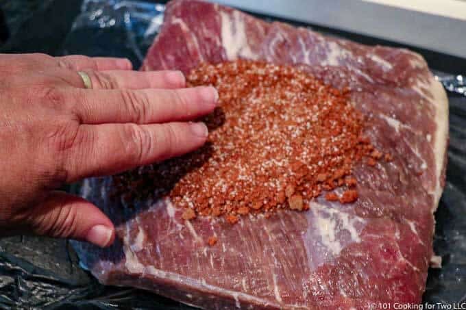 applying rub to brisket