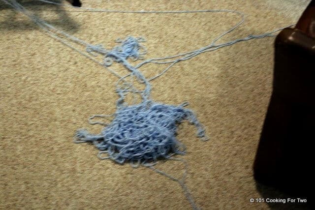 A ball of yarn distroyed on the floor