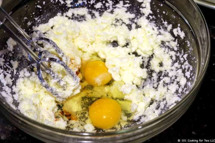 eggs added to bowl with mixer