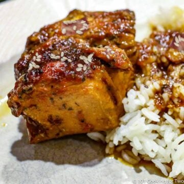 honey garlic chicken on a white plate with rice