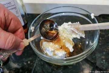 adding syrup to cream cheese in bowl