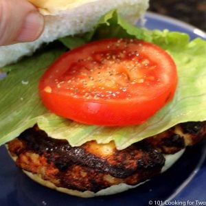 chicken burger on a bun with tomato