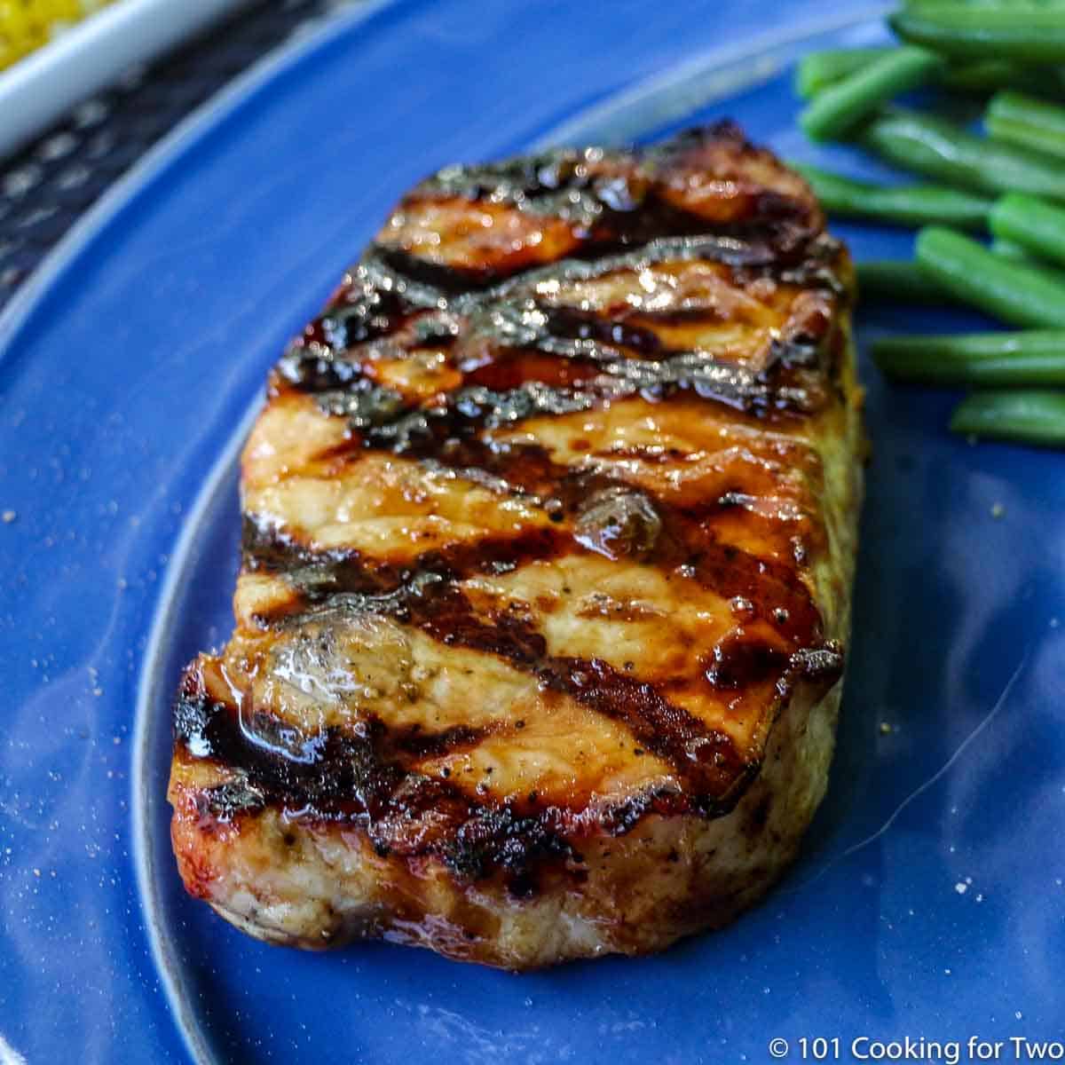 Apricot Glazed Grilled Pork Chop with green beans.