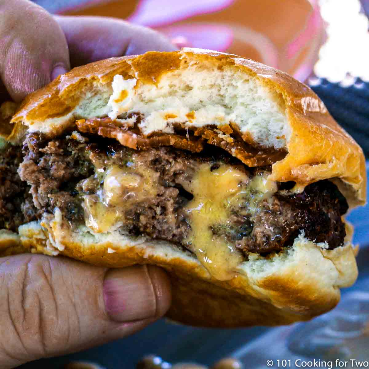 Juicy Lucy Burgers with a large bite out of it.