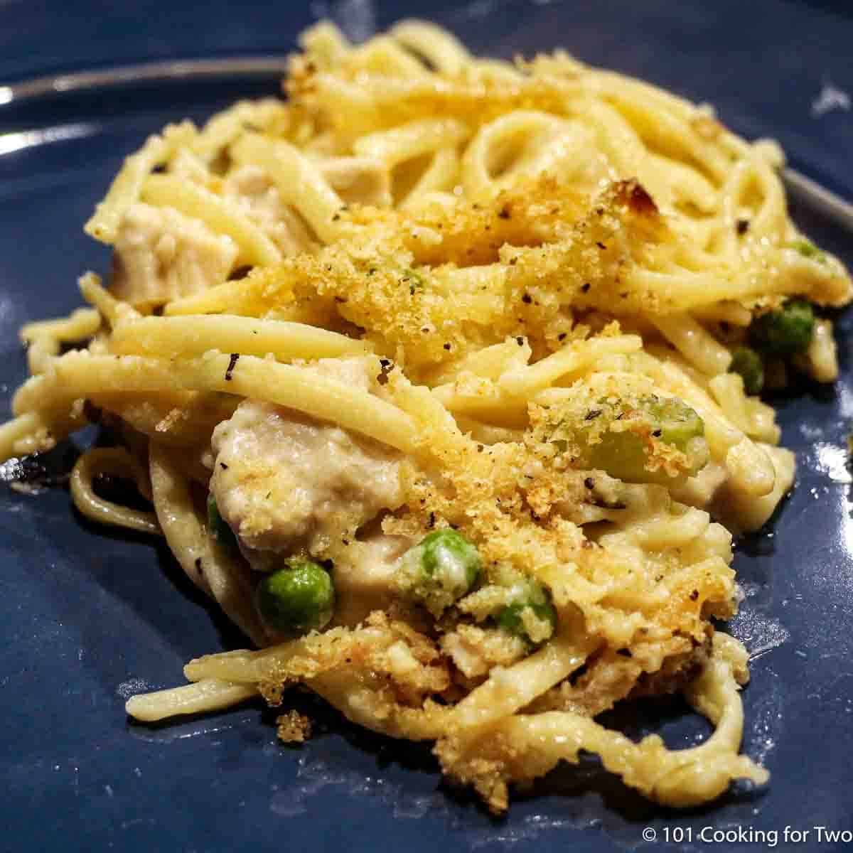 A large serving of turkey tetrazzini on a blue plate.