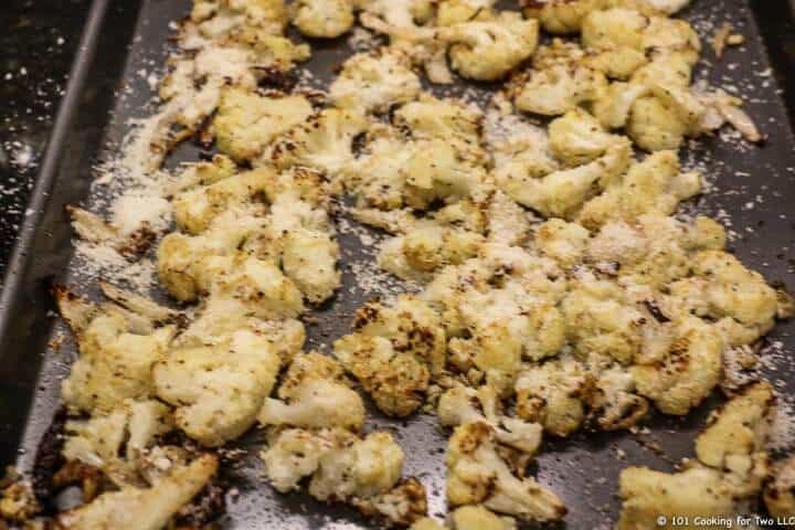 Cauliflower on tray sprinkled with cheese