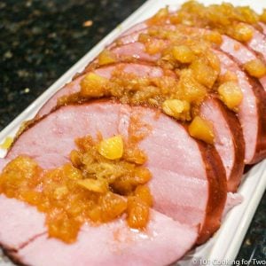 slices of ham with pineapple on white plater