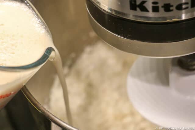 image of adding the proofed yeast mixture to the stand mixer with flour