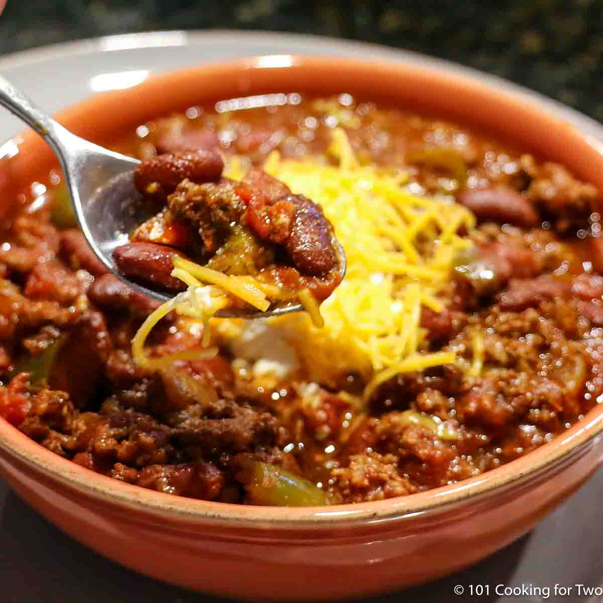 orange bowl with chili with cheese.