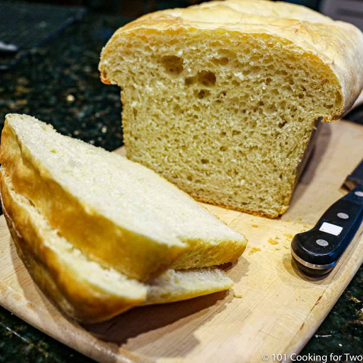 A loaf of bread sliced on a board.