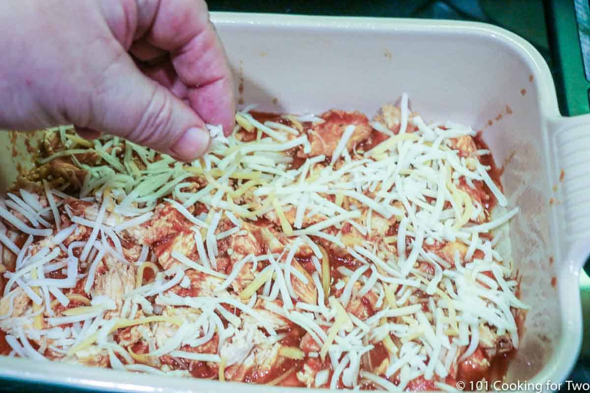 sprinkling shredded cheese over the casserole