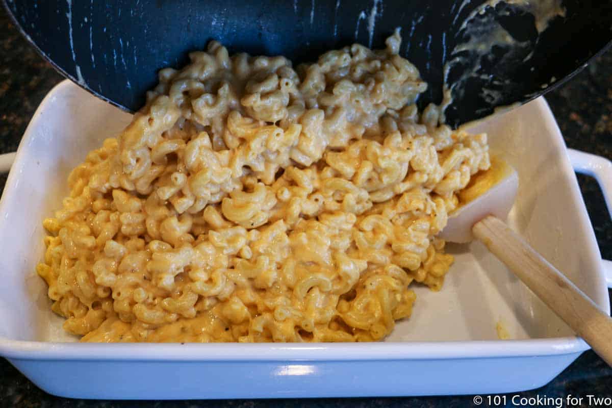 Moving sauce and pasta to casserole dish.