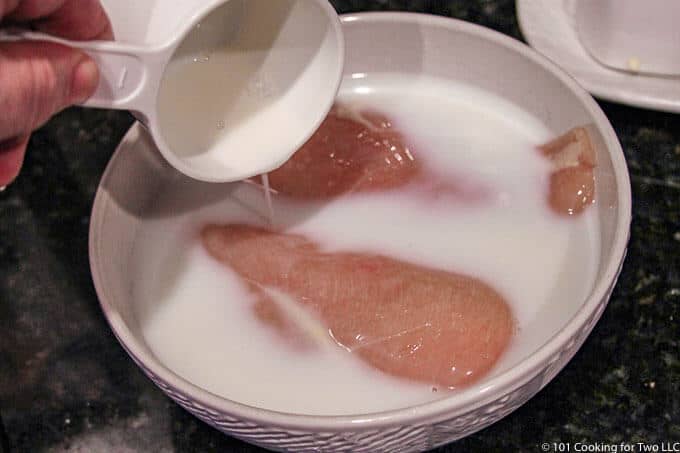 adding milk to bowl with chicken