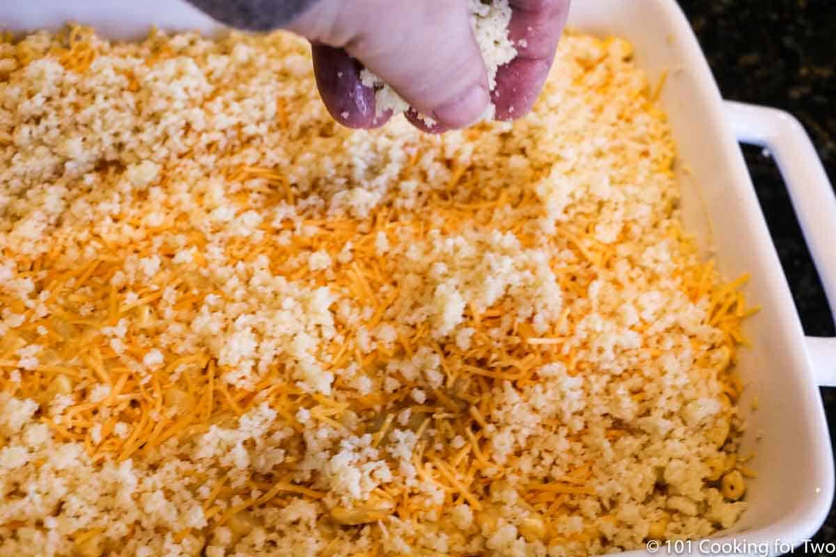 adding topping to casserole dish.