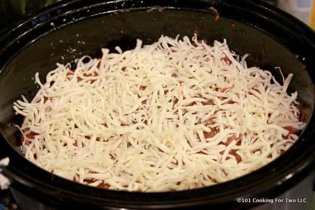 image of adding cheese to the final layer in the crock pot
