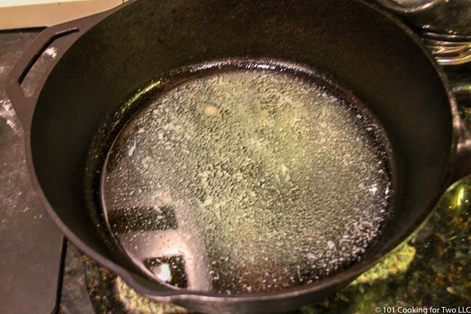 image of melted butter in large black pan