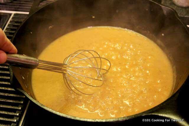 image of wisking gravy boiling in a black pan