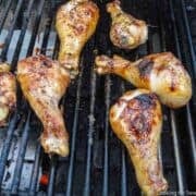chicken drumsticks cooking on the grill