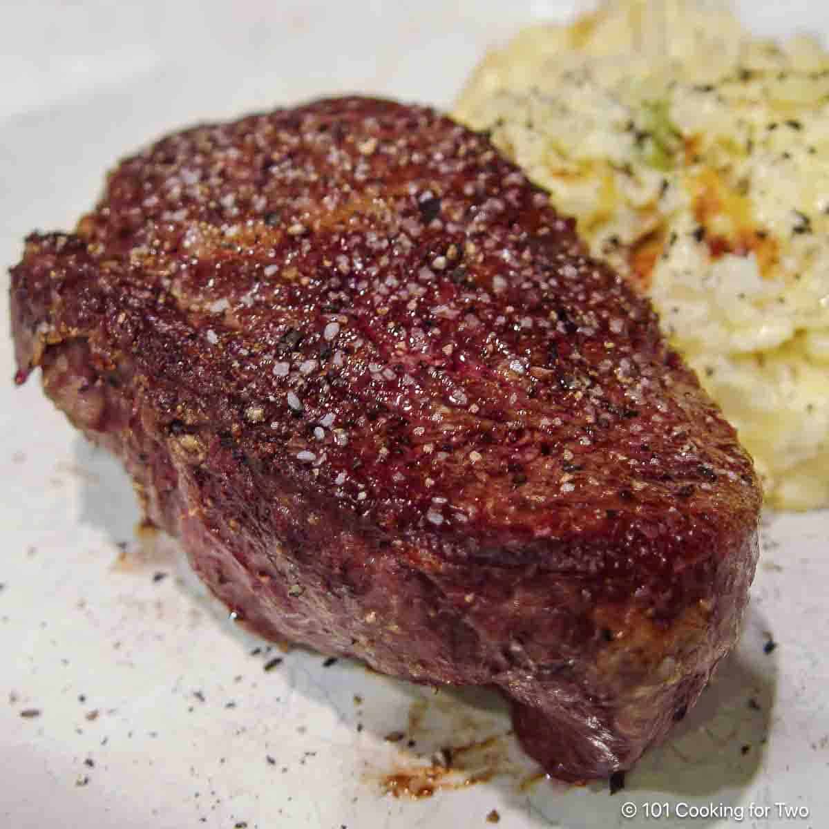 filet with potatoes on a white plate.