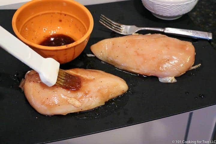 brushing chicken with glaze