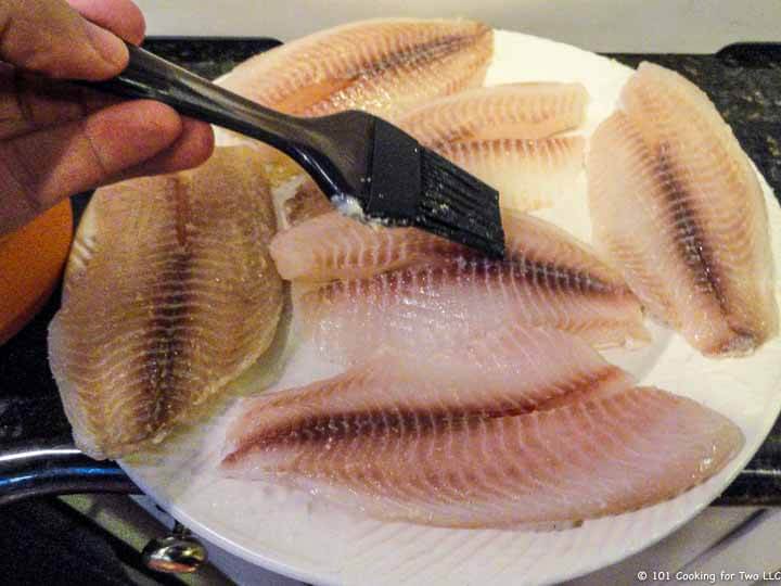 brushing the fish with butter mixture