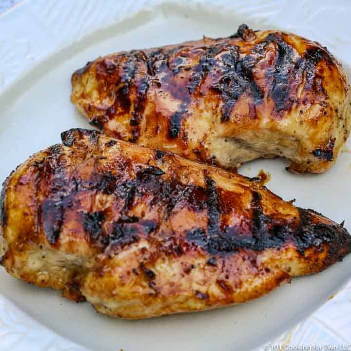 two chicken breast on a white plate
