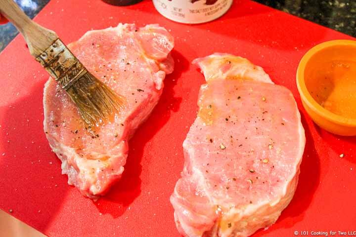 brushing coating on pork chops.