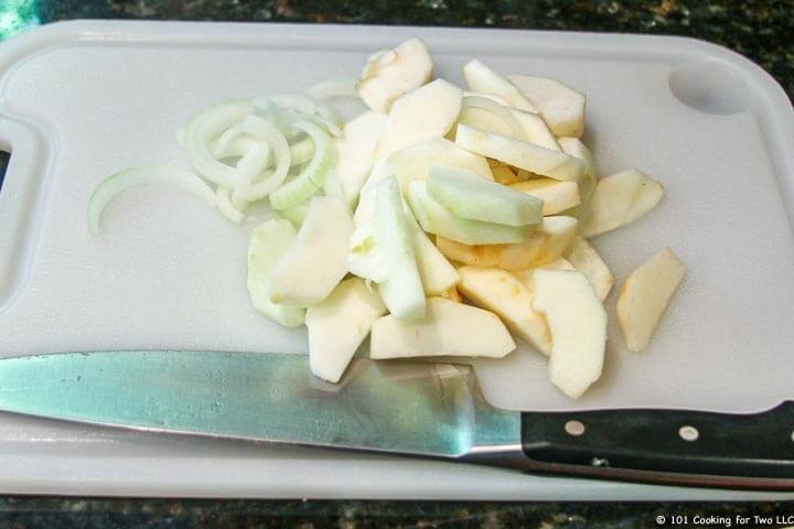 slice apples and onion on board.