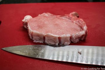 trimmed pork chop on red board-2