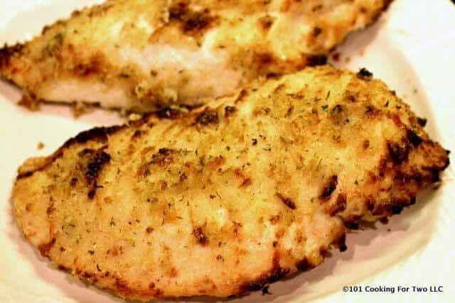 Picture of nicely browned Parmesan Baked Chicken Breast on a white plate