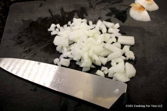 image of a chopped onion on a black chopping board