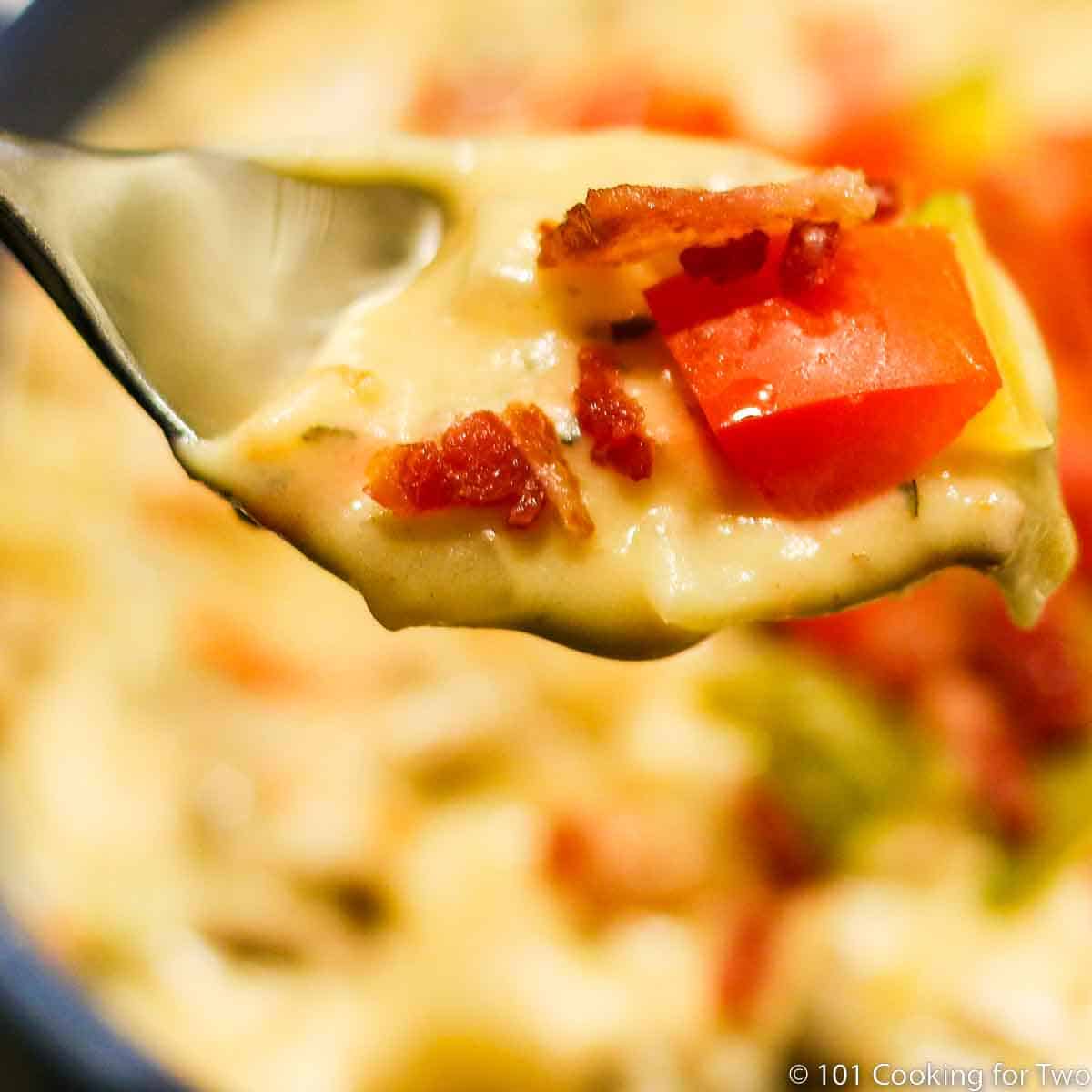 A spoon full of Extra Thick Crock Pot Cheeseburger Soup