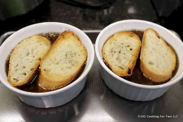toasted crusty bread on top of the soup